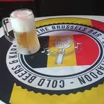 Close-up of a freshly poured Belgian beer with a thick creamy head.