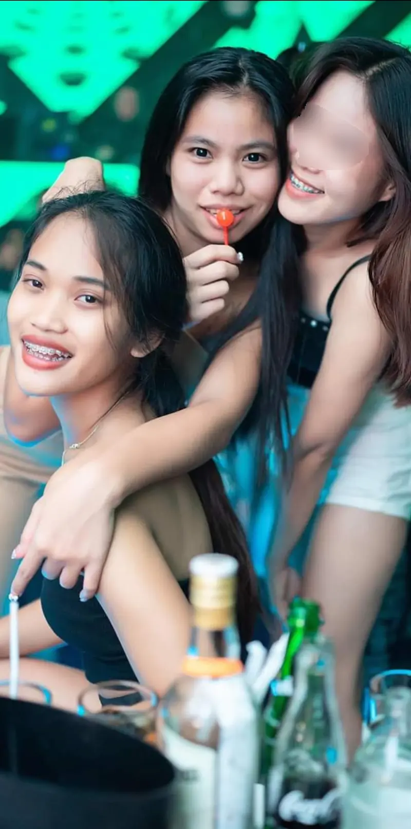 Three bar staff members sharing a friendly moment.