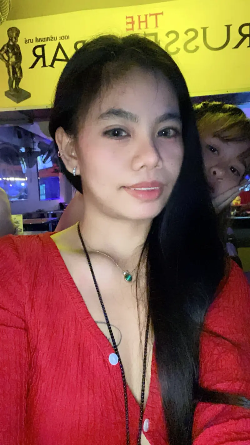 Thai waitress smiling at customer.