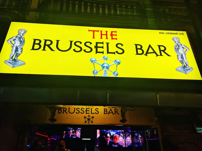 The neon sign of the Brussels bar shining in the night.