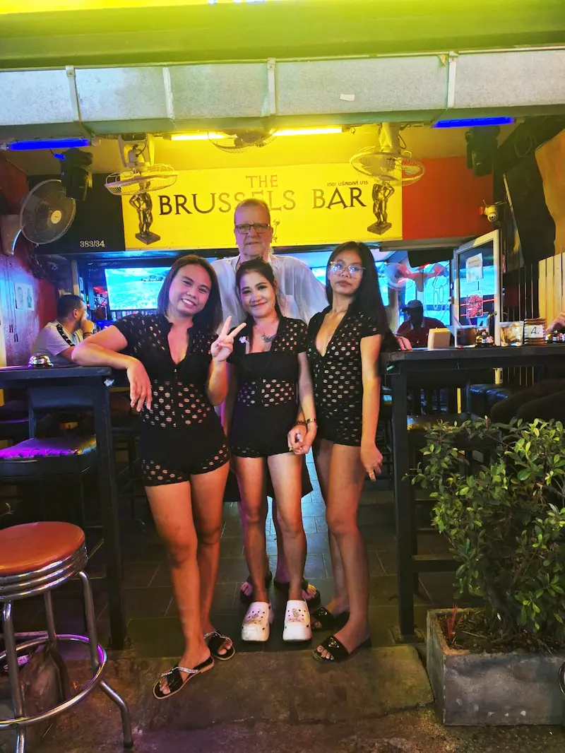 Group photo of the owner and waitresses in front of the bar in soi Chaiyaphoon.