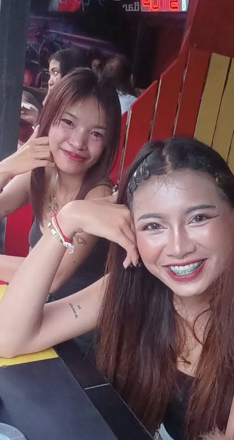 Two waitresses from the team posing together at the entrance.