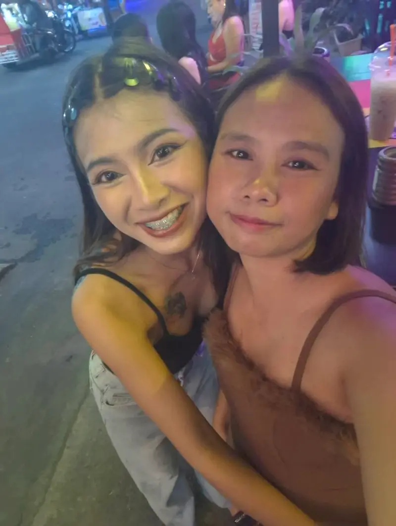 Two waitresses in uniform ready for service.